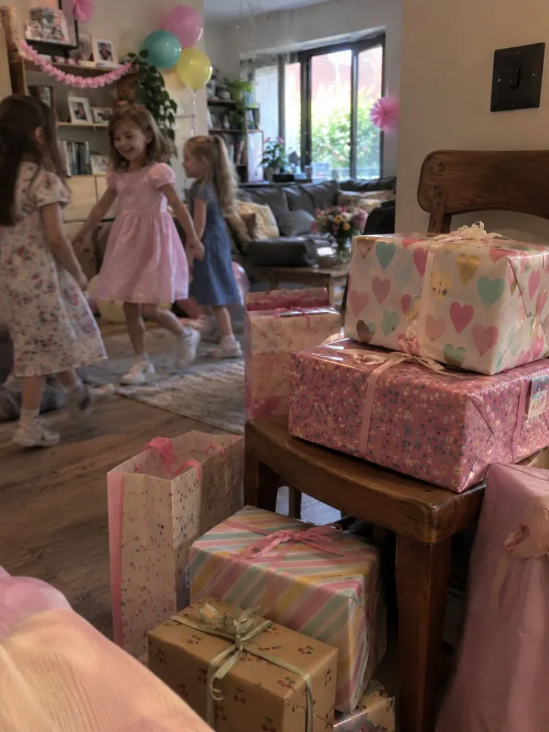 The gift table, covered in pink and kraft paper parcels.