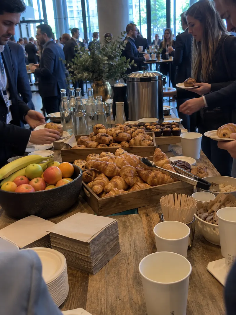 The coffee-break buffet: pastries, fruit and paper cups.