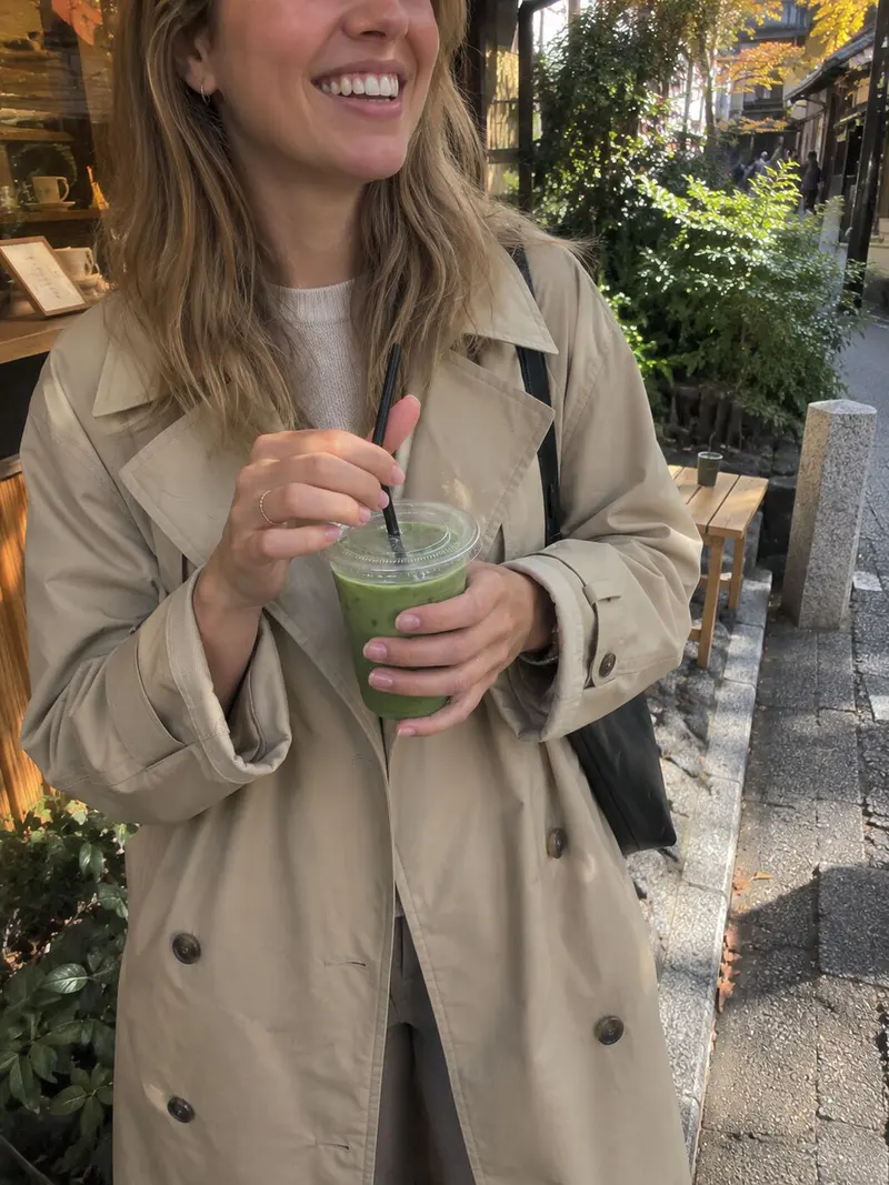A friend smiles, iced matcha in hand.