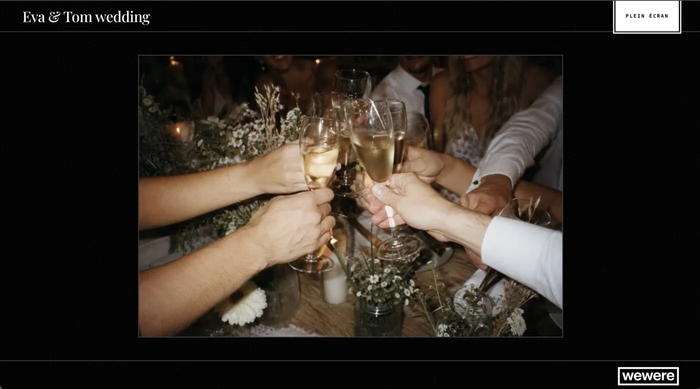 The live wall on a TV: a photo of a champagne toast in the middle of the screen, with the event name at the top.